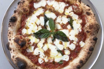 a pizza sitting on top of a plate of food